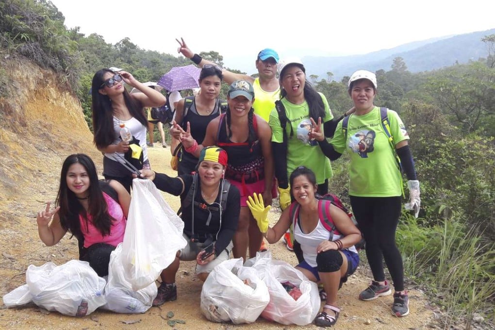 Liza Avelino (centre in cap and pink shorts) and her cleanup team.