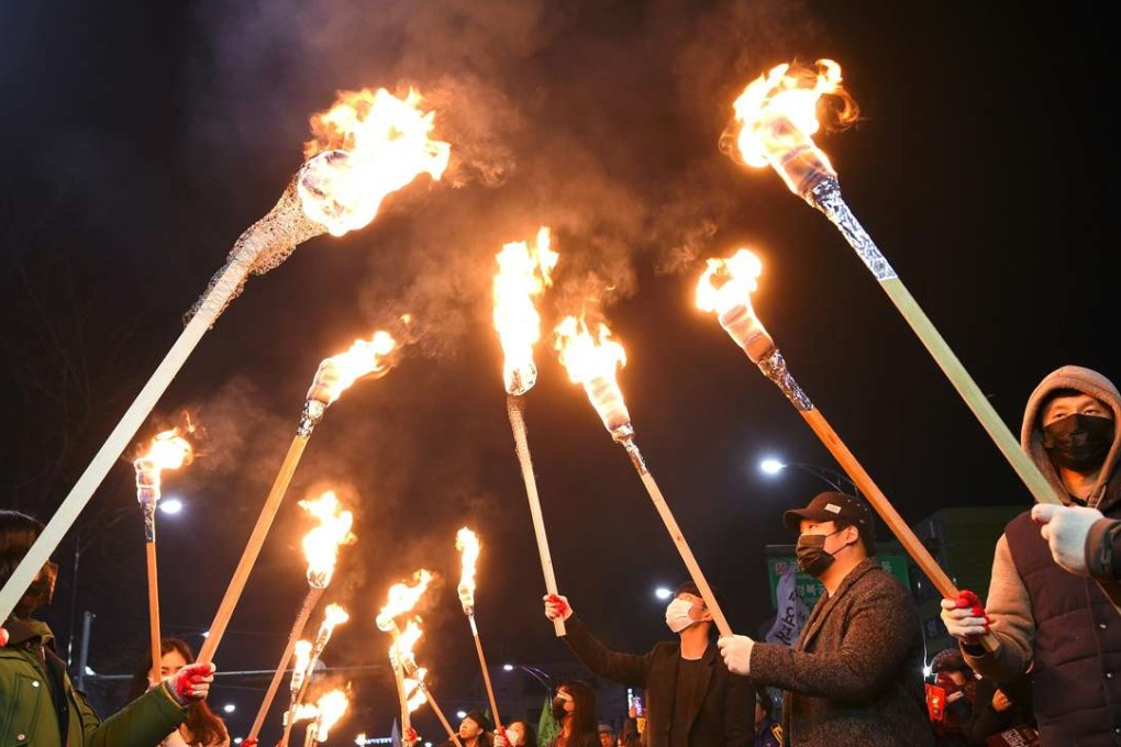 Protesters march towards the presidential Blue House during a rally against South Korea’s President Park Geun-Hye in Seoul. The president’s exit from office seems assured, but her successor is far from clear. Photo: AFP