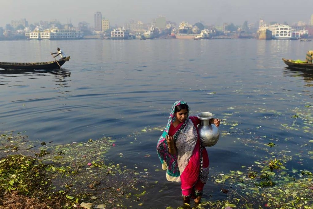 A Bangladeshi woman collects water from a river in Dhaka. The advent of tube wells appeared to have given rural Bangladeshis a source of clean water, but there was a major drawback - arsenic. Photo: AFP