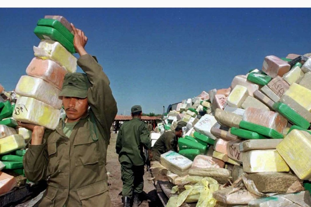 A Mexican soldier carries blocks of cocaine to a pile for incineration at a naval base in Matamoros. Photo: Reuters
