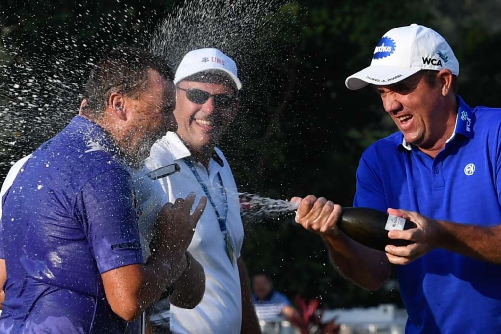Aussie Sam Brazel gets a champagne bath from compatriot Scott Hend after birdieing the last hole to win the UBS Hong Kong Open. Photos: Richard Castka