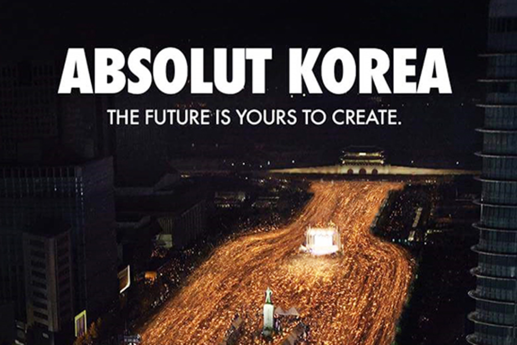 An image of the candlelit rally held in Gwanghwamun Square, downtown Seoul, is visualized as the shape of an Absolut Vodka bottle in this advertisement. Photo: Absolut Vodka Korea