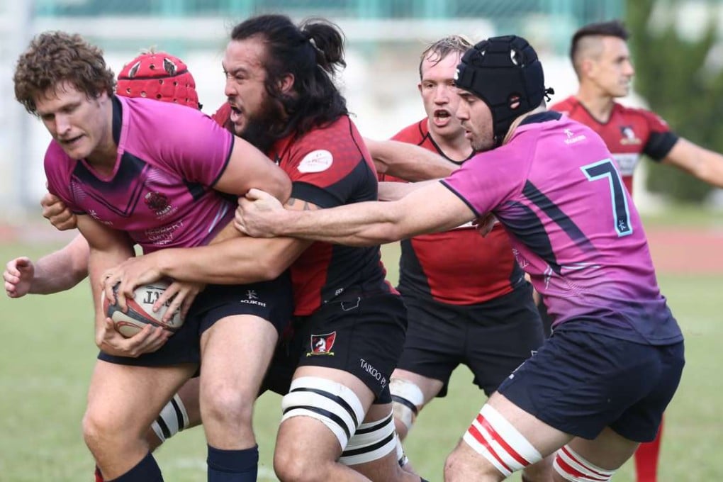 Karetai Williams wraps up his HKCC opponent during Valley’s narrow victory. Photo: Jonathan Wong