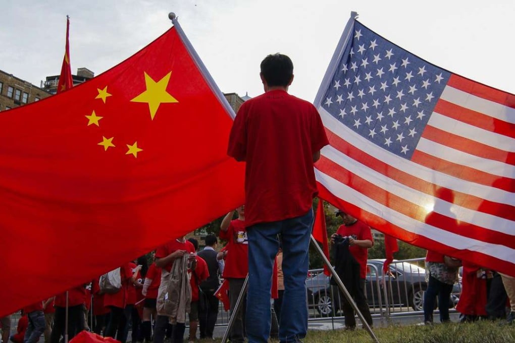 Demonstrators hold the national flags of China and the United States ahead of President Xi Jinping’s state visit at the White House in September 2015. Photo: EPA