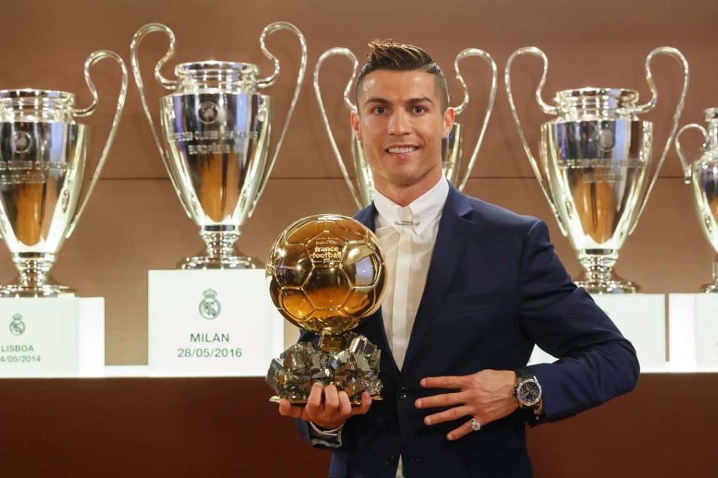 Cristiano Ronaldo posing with the Ballon d'Or France Football trophy at the Trophy Room of the Santiago Bernabeu stadium in Madrid. Photo: AFP