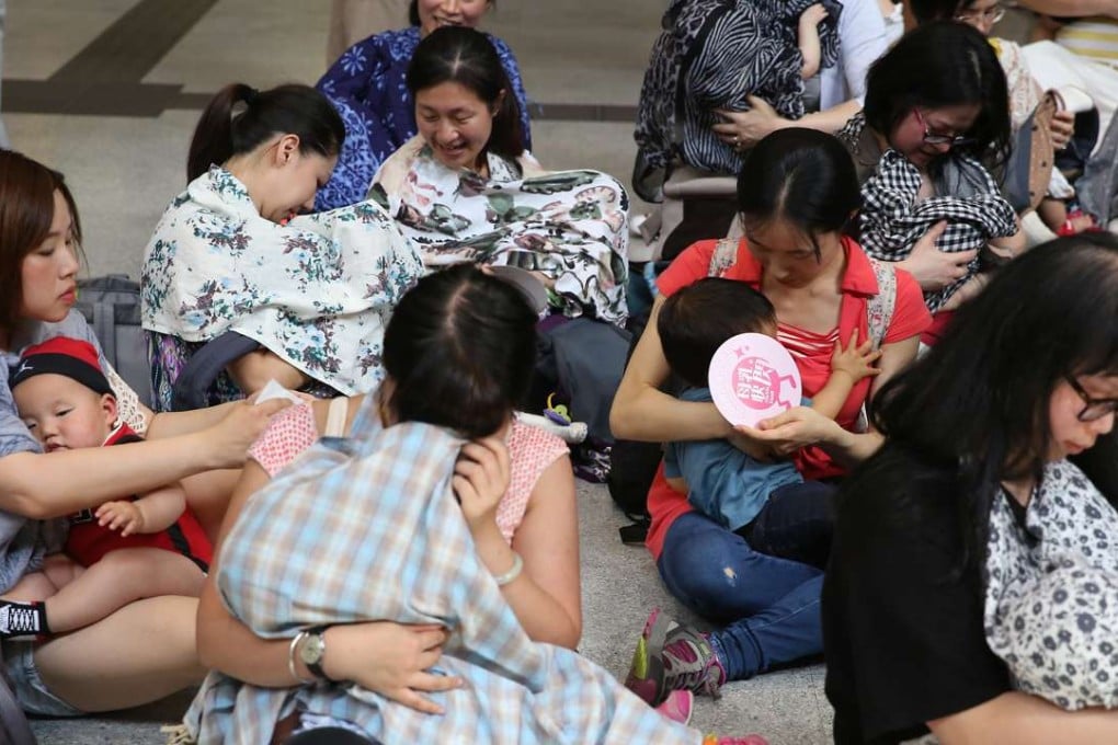 Breastfeeding mothers gathered at Tai Wai MTR Station during a Breastfeeding FlashMob to call for legislation to protect nursing mothers. Photo: Sam Tsang