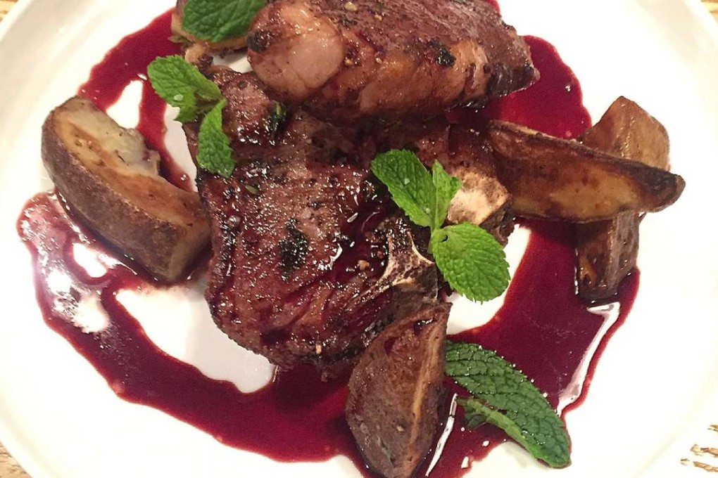 Lamb T-bone with red wine reduction and roast potatoes.