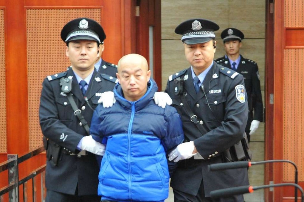 Serial killer Zhao Zhihong is escorted to stand trial for murder, rape, robbery and larceny at the Intermediate People's Court in Hohhot, capital of the Inner Mongolia Autonomous Region, on February 9, 2015. Zhao, 42, who was sentenced to death, was apprehended in 2005 and confessed to a string of rapes and murders, including one pinned on 18-year-old Huugjilt, who was wrongly executed for the crime. Photo: Xinhua