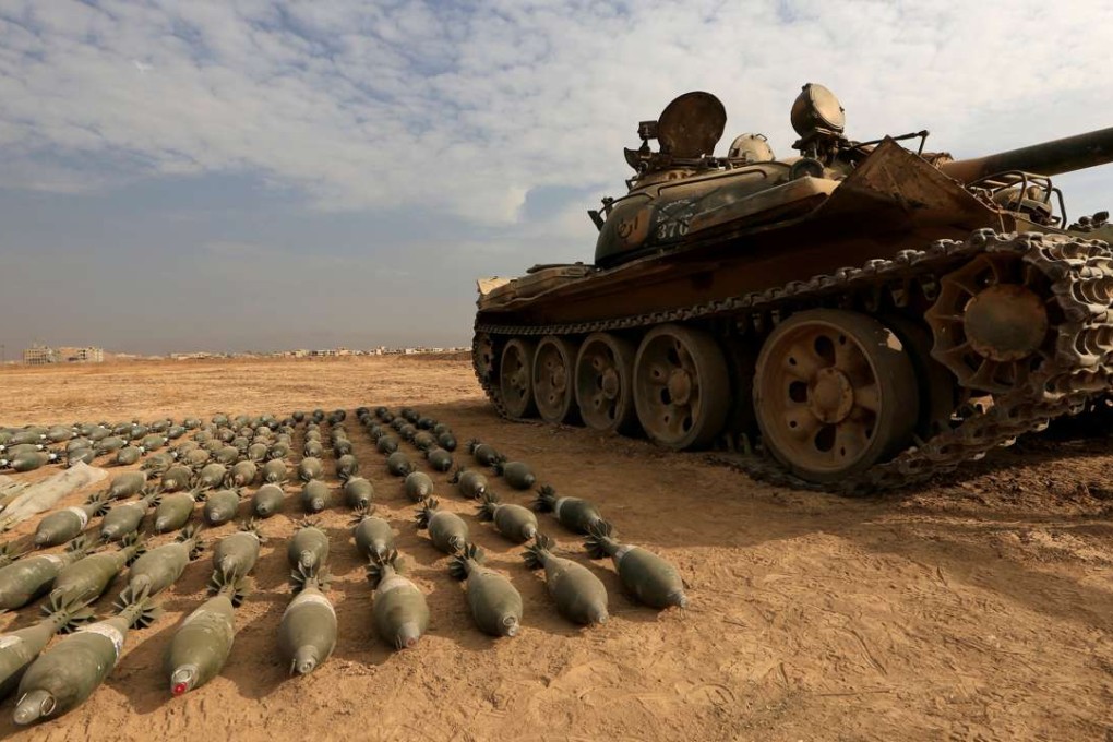 A captured Islamic State tank and shells are seen at the Iraqi army base in Qaraqosh. Photo: Reuters