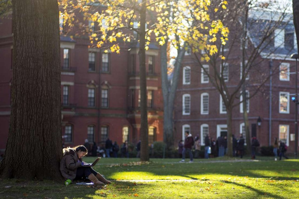 A student sits in the sun near the end of the day on the Harvard campus in Cambridge, Massachusetts. Your son or daughter should still strive for the best education. On a personal level, graduating from Harvard or Oxbridge will make them highly employable. Photo: EPA