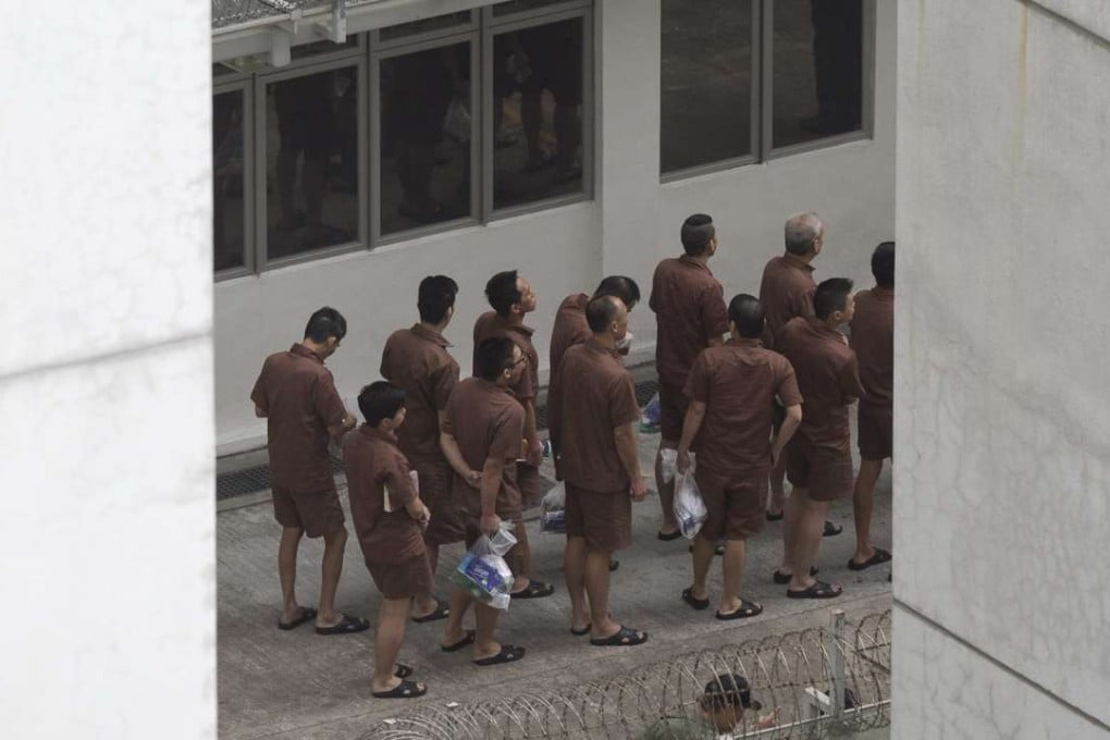 Prisoners line up at the Lai Chi Kok Reception Centre on November 3. Hong Kong’s overall prison population is declining, and the Correctional Services Department can take credit for lower recidivism. Photo: EPA