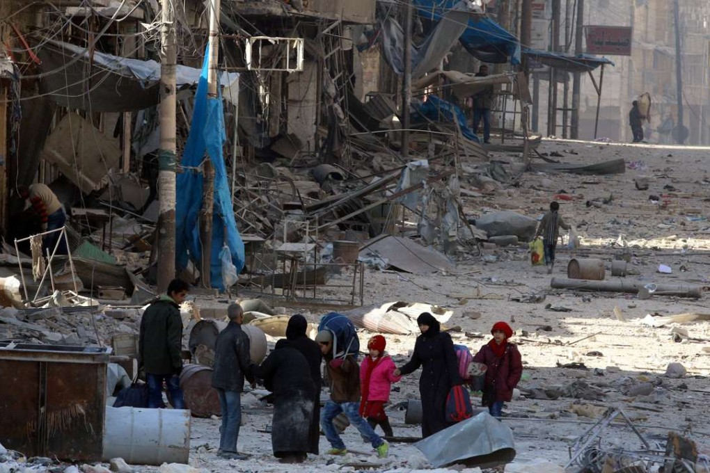 Syrians walk over rubble of damaged buildings, while carrying their belongings, as they flee clashes between government forces and rebels in Tariq al-Bab and al-Sakhour neighborhoods of eastern Aleppo towards other rebel held besieged areas of Aleppo. Photo: Reuters