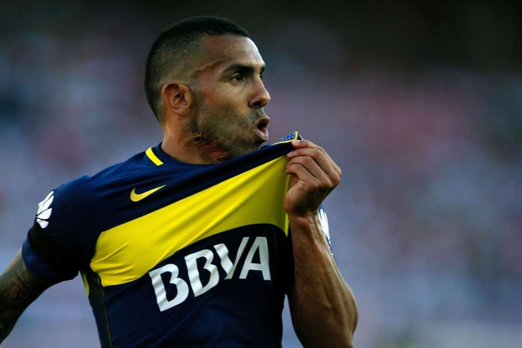 Boca Juniors' forward Carlos Tevez kisses the badge after scoring against city rivals River Plate at the weekend. Photo: AFP