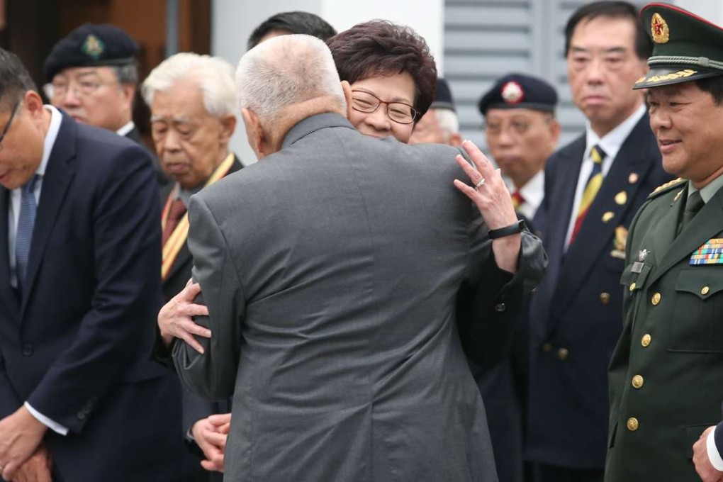 Former chief executive Tung Chee-hwa gives Chief Secretary Carrie Lam a hug during the official ceremony in Shau Kei Wan to commemorate the Nanking massacre. Photo: K. Y. Cheng