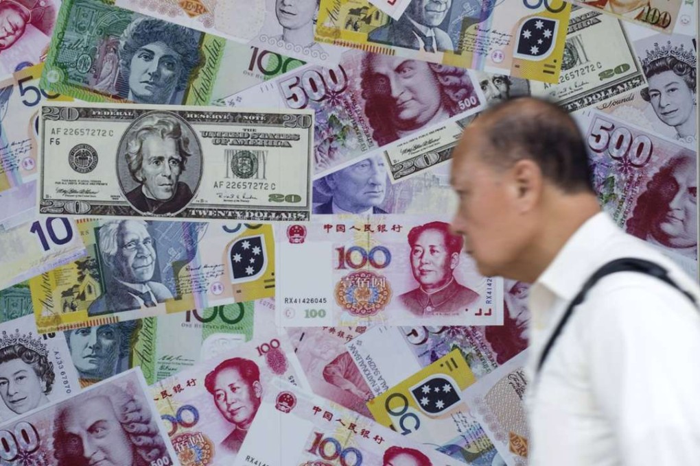 A man walks past an advertisement promoting China's renminbi (RMB) or yuan, U.S. dollar and Euro exchange services at a foreign exchange store in Hong Kong. China’s government bonds tumbled by their daily allowable limits on Thursday after the US Fed foreshadowed three possible interest rate increases in 2017, one more than consensus. Photo: Reuters