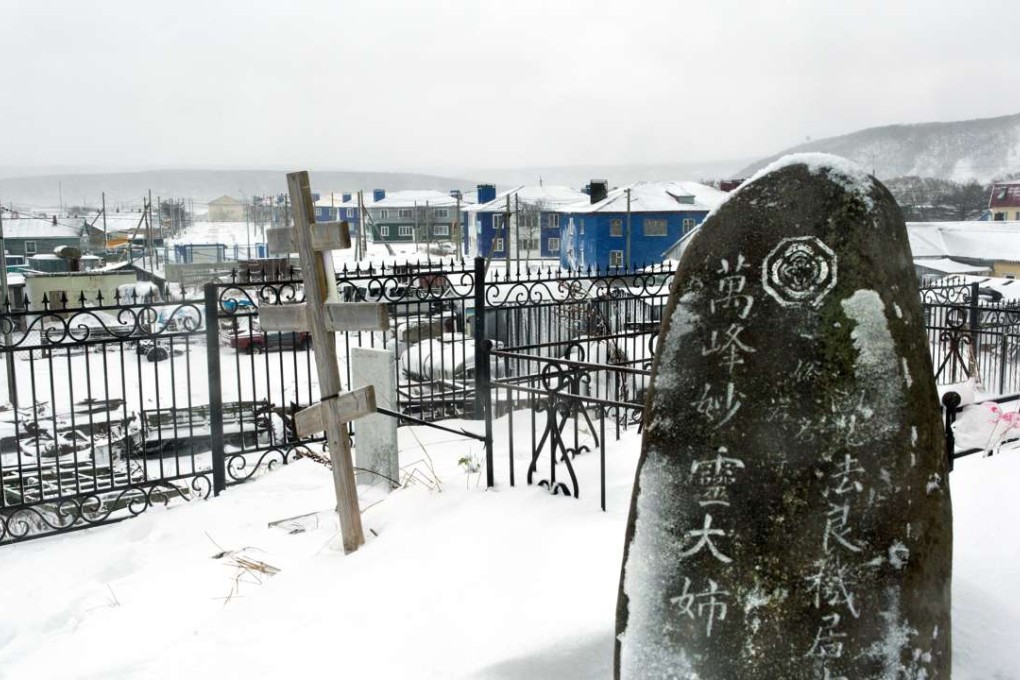 A Russian Orthodox cross next to a Japanese gravestone at a cemetery outside Kurilsk town on the island of Iturup in the Kurils. Photo: AFP