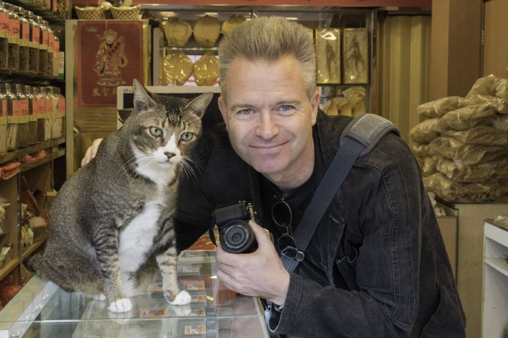 Hong Kong shop cat photographer Marcel Heijnen and one of his subjects.