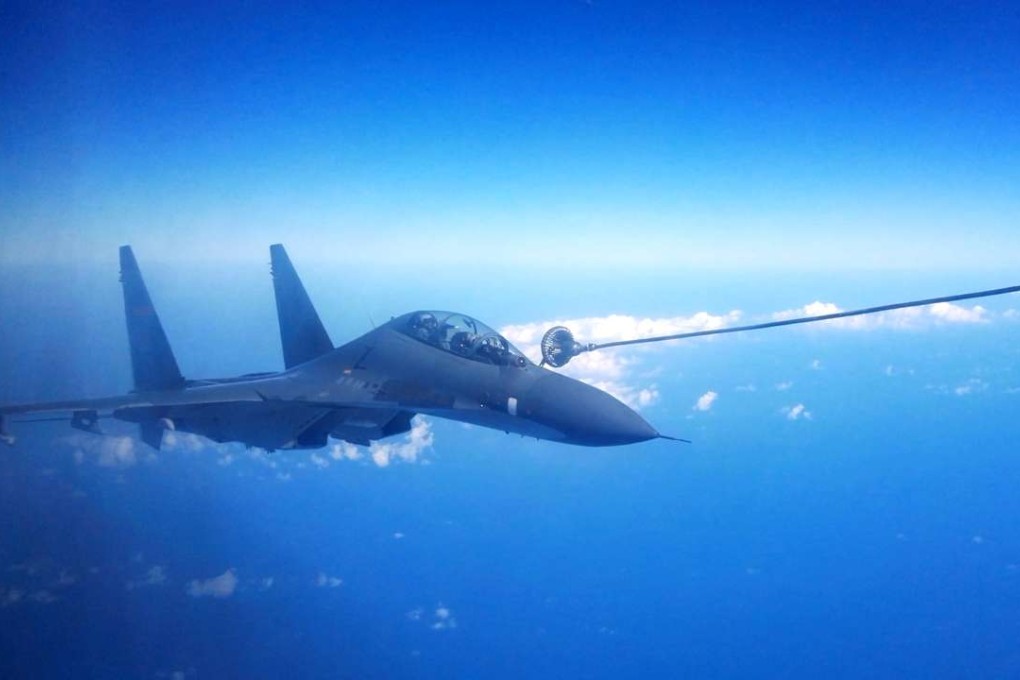 A Su-30 fighter of the Chinese Air Force gets fueled in the air during a drill. Photo: Xinhua