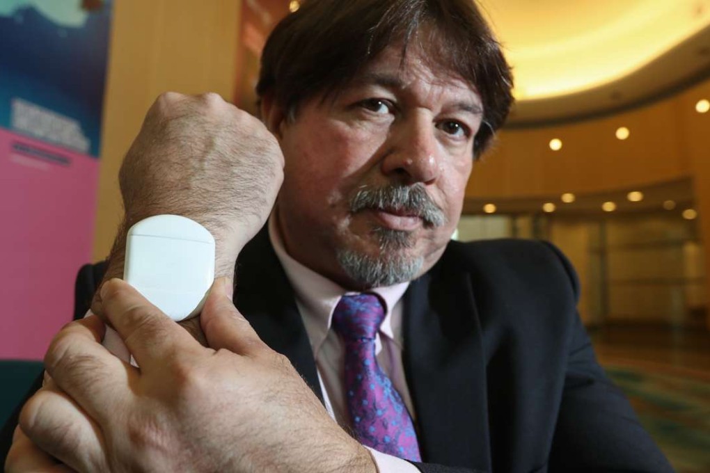 Researcher Luis Eduardo Cordova-Lopez demonstrates the use of a wireless blood sensor. Photo: Bruce Yan