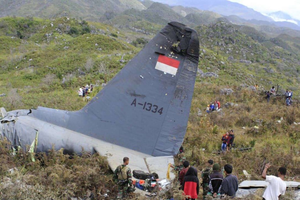 Rescuers collect personal belongings of the victims of an Indonesian Air Force plane that crashed in the mountainous area in Wamena, Papua province. Photo: AP