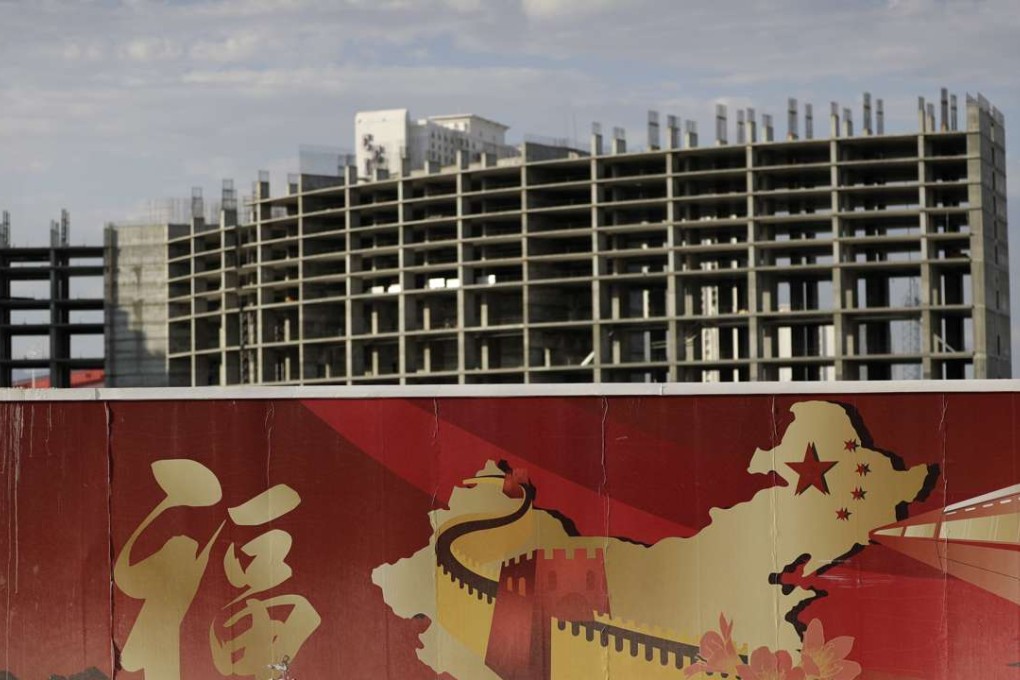 A wall with symbols of China partially blocks the view of an Asian-themed casino under construction in Las Vegas. Photo: AP