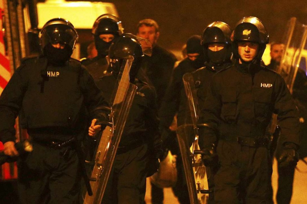 Prison officers in riot gear arrive at Winson Green prison. Photo: Reuters