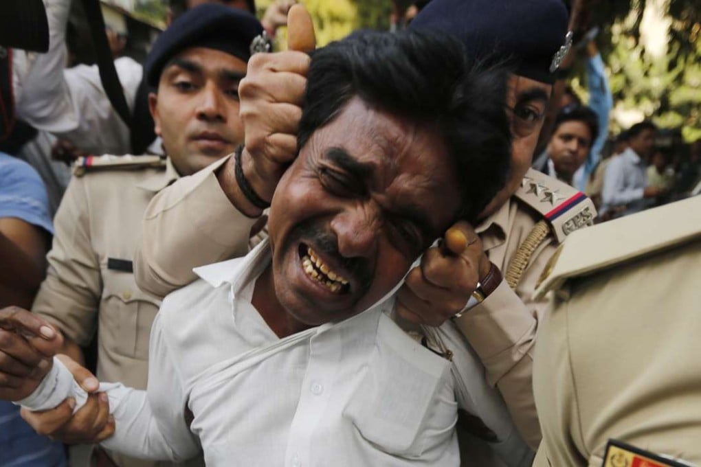 Indian policemen detain an activist. Photo: AP