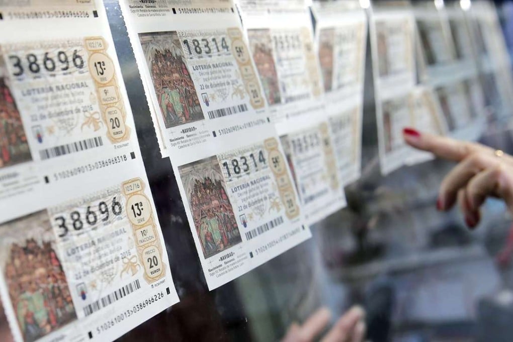 A woman buys a Christmas lottery ticket at a lottery outlet in Valencia, Spain. Photo: EPA