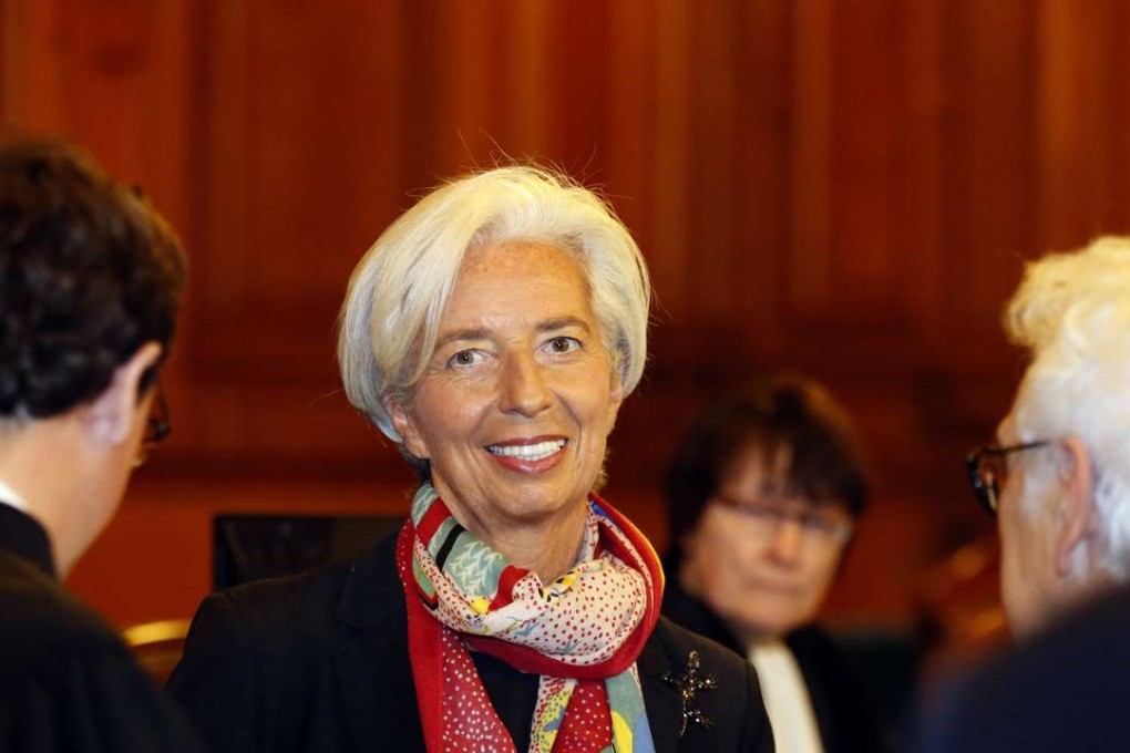 Christine Lagarde, managing director of the International Monetary Fund, stands inside the courtroom and next to members of her legal team. Photo: AP