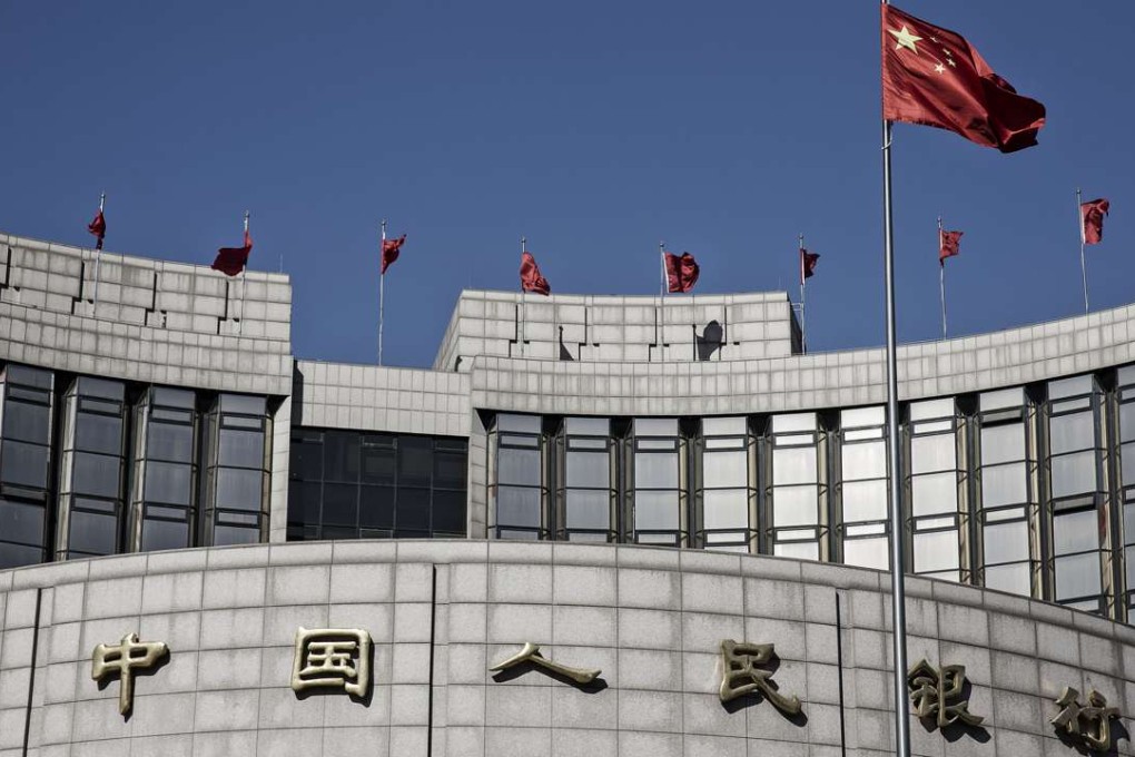 The Chinese national flag flies above the People's Bank of China head office in Beijing. Photo: Bloomberg