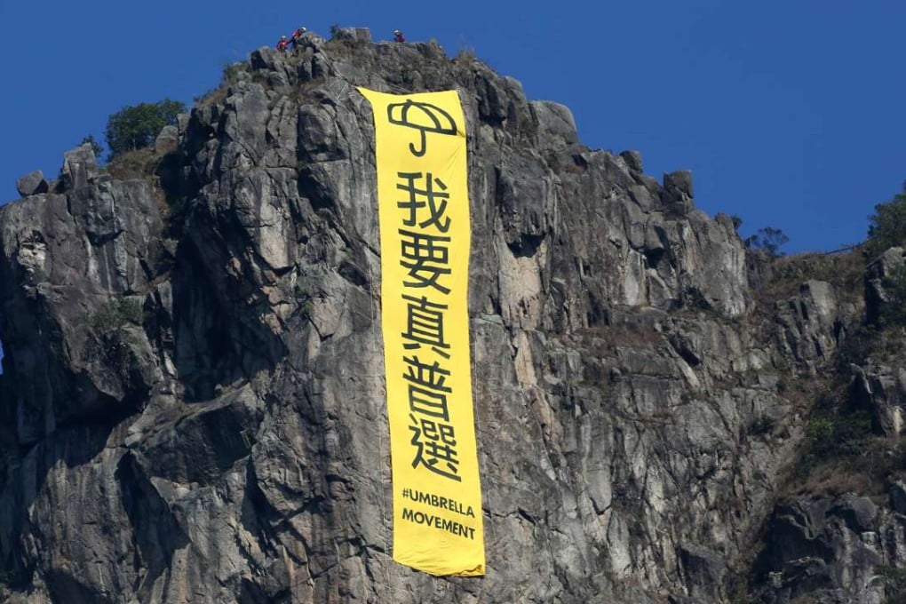 A banner hangs from Lion Rock in 2014, calling for “true universal suffrage”. Photo: Nora Tam