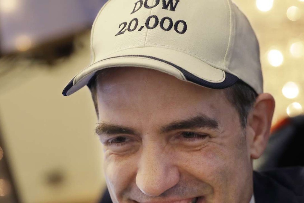 Stock trader Gregory Rowe smiles a he wears a "DOW 20,000" hat at the New York Stock Exchange on Tuesday, December 20, 2016, in New York. Photo: AP