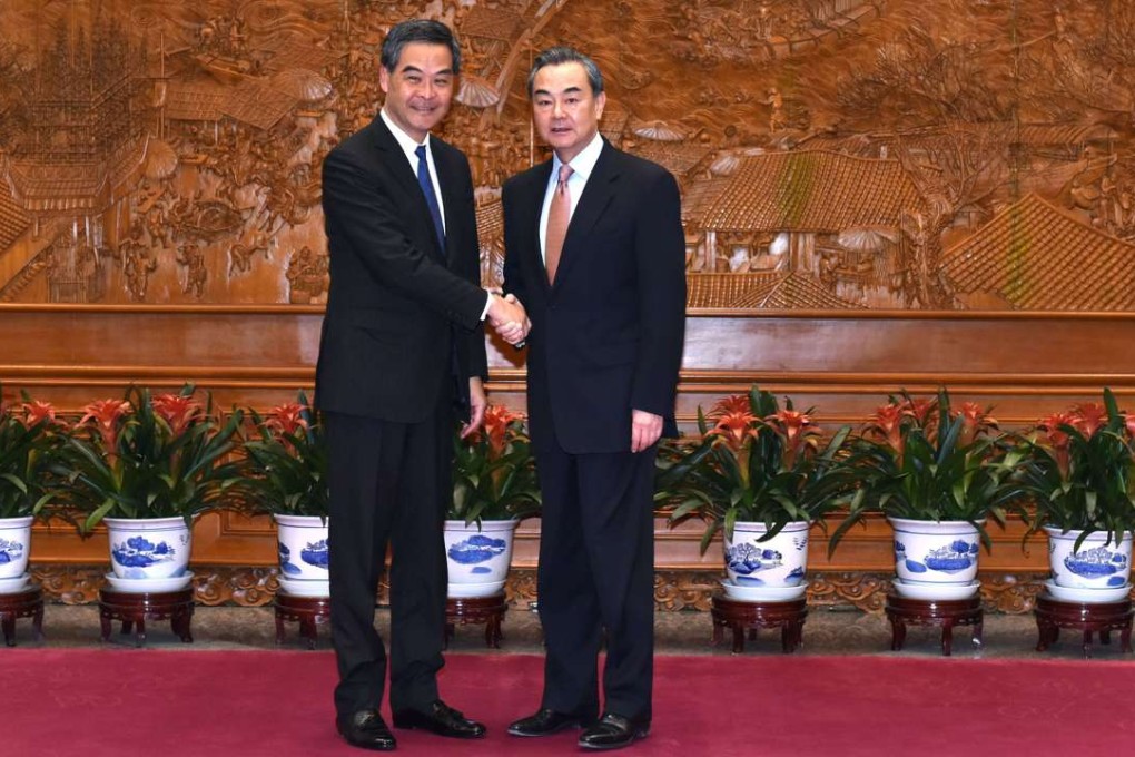 Leung Chun-ying (left) and Wang Yi meet in Beijing on Leung’s first day of his final duty visit. Photo: ISD