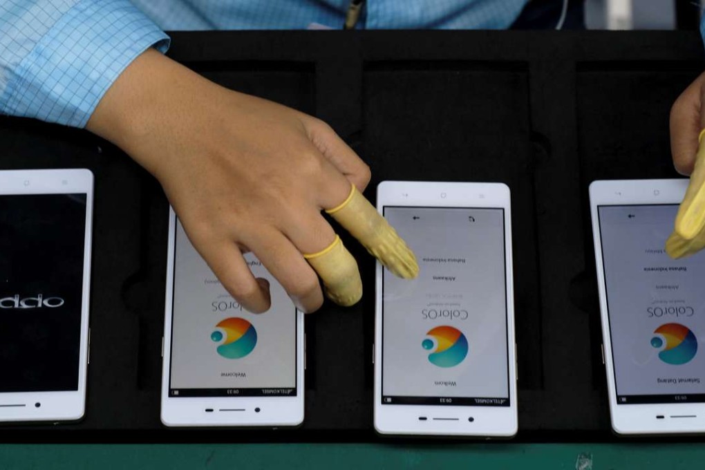 A worker tests smartphones at an Oppo smartphone factory in Tangerang, Indonesia. Photo: Reuters