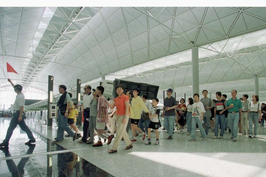 A guide leading tourists through Hong Kong International Airport. Photo: Reuters