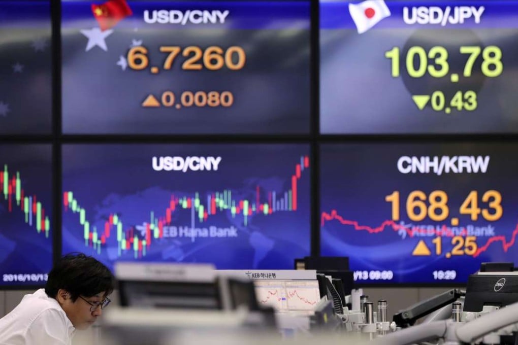 A currency trader follows the market at the foreign exchange dealing room in Seoul. Photo: AP