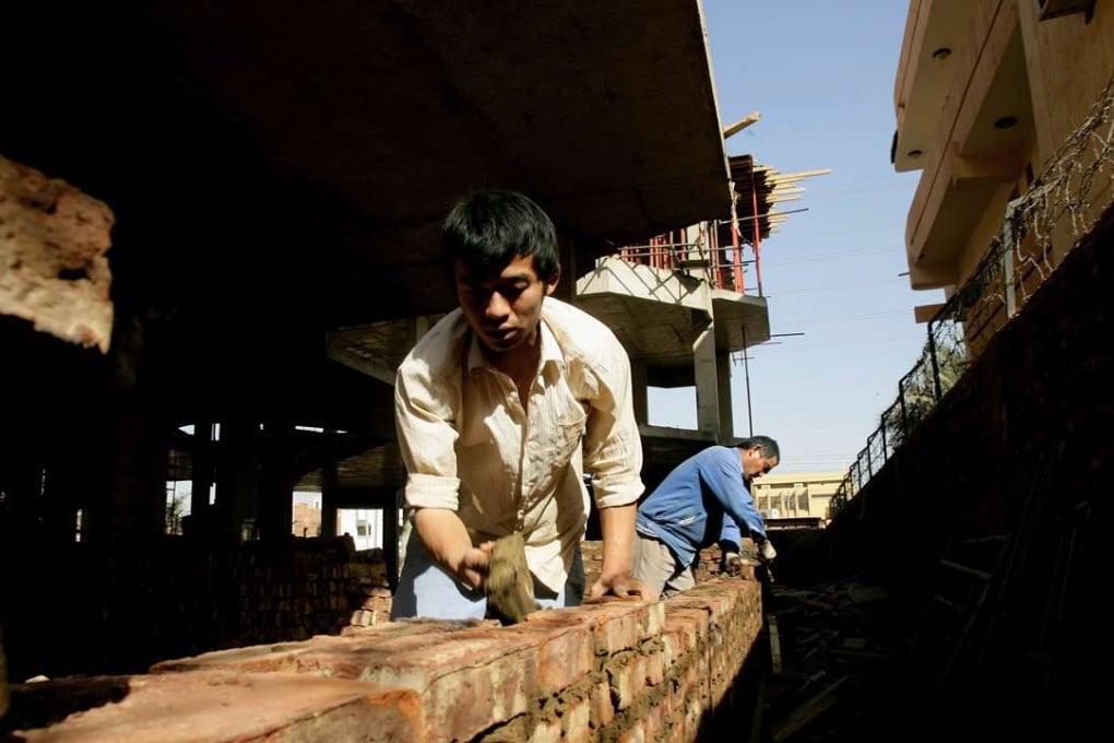 Chinese workers build a wall at a construction site in Khartoum, Sudan. China pours billions of dollars in investment in Africaeach year. Photo: AFP