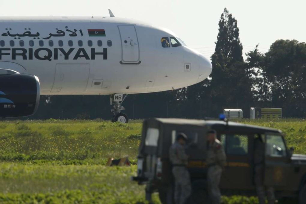 Maltese troops survey a hijacked Libyan Afriqiyah Airways Airbus A320 on the runway. Photo: Reuters