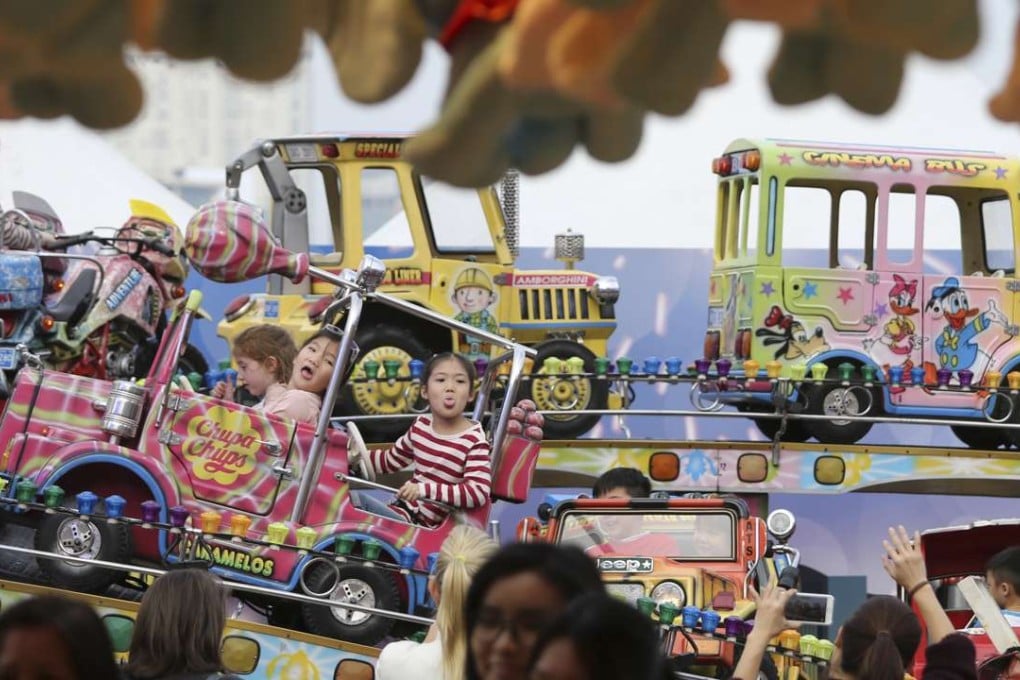 Children enjoy one of the rides at the AIA Great European Carnival in Central. It is tragic that, despite two unanimous votes in favour in the Legislative Council, the government has still not created a children’s commission. Photo: May Tse
