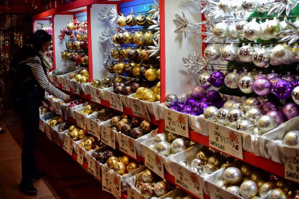 A woman looks at Christmas ornaments at a shop in Tlapujahua, Michoacan State, Mexico, which has several factories making them. Photo: AFP
