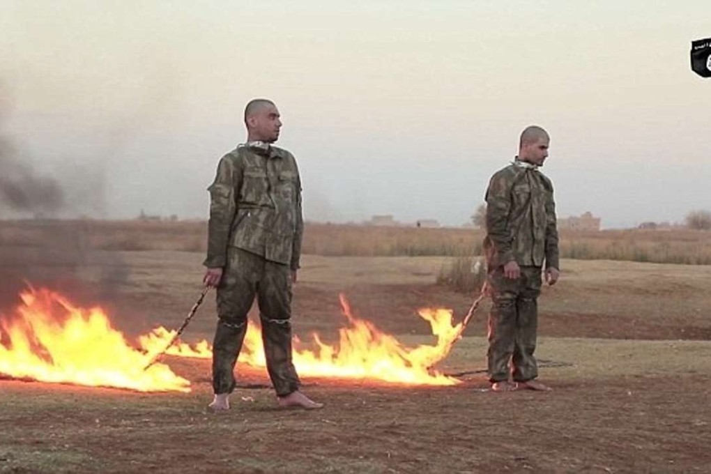 Flames advance on two chained men, purported to be captured Turkish troops, before they are engulfed, in a scene from a video released by the Islamic State's mouthpiece Amaq news agency. Photo: Amaq