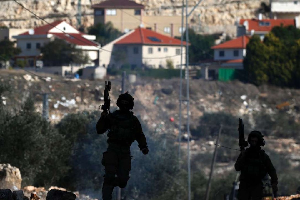 Israeli soldiers near a settlement during clashes following a protest against the expropriation of Palestinian land by Israel in the occupied West Bank. Photo: AFP
