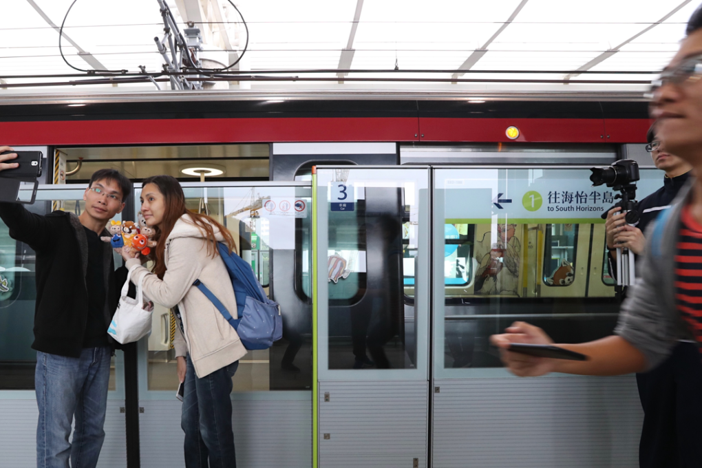 People take selfies at Ocean Park Station during the opening day of the MTR South Island Line. Photo: Bruce Yan
