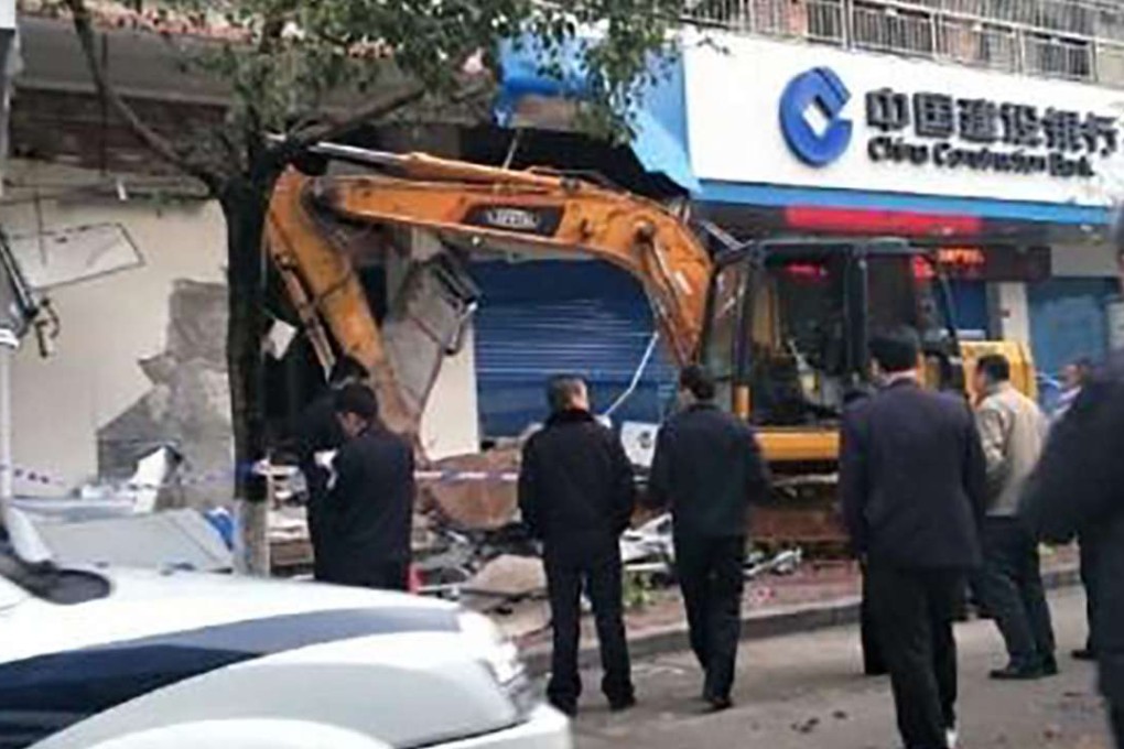 Police examine the excavator used in the failed robbery attempt. Photo: Handout