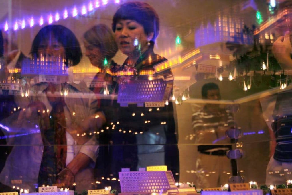 People examine plans for the BP International Education Park, now home to two international schools, in Yizhuang, Beijing, in May 2012. Photo: Simon Song