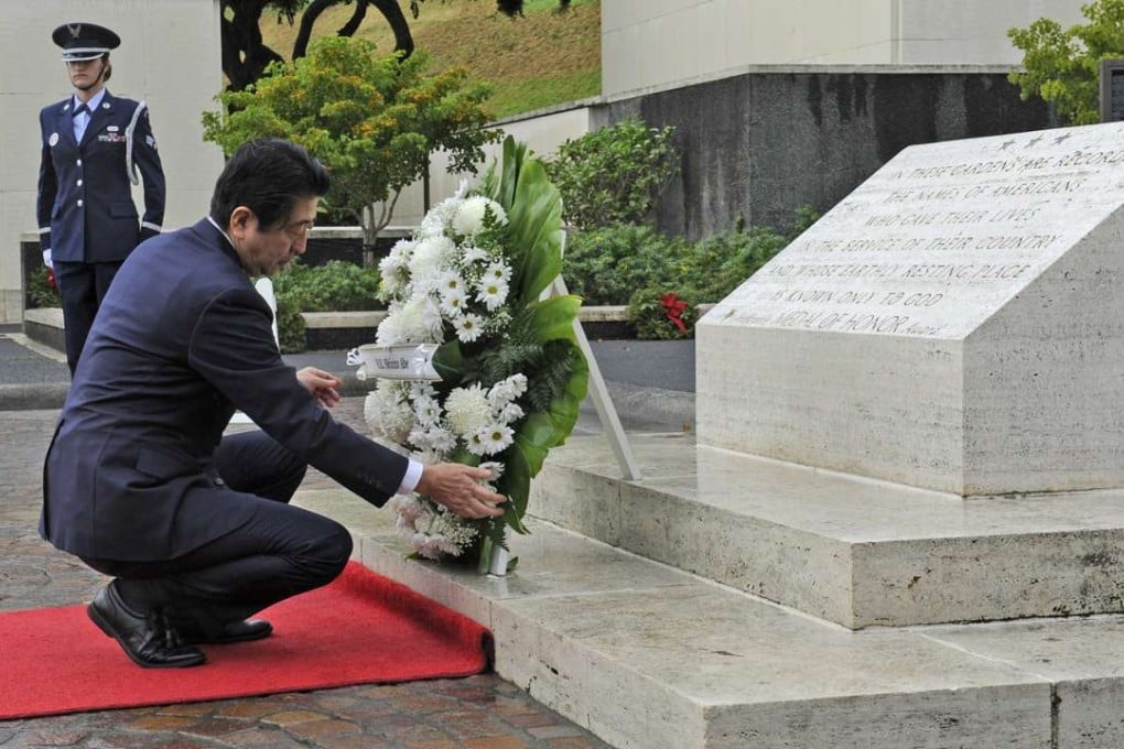 Japanese Prime Minister Shinzo Abe visits the National Memorial Cemetery of the Pacific to place a wreath at the Honolulu Memorial. Photo: AP