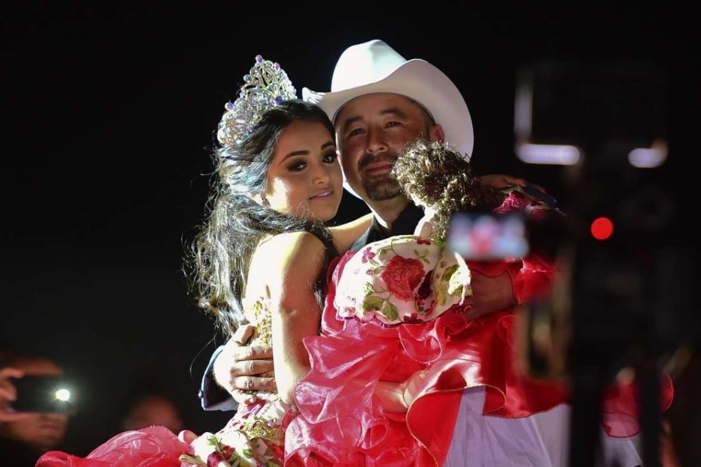 Rubi Ibarra and her father Cresencio Ibarra dance during the celebration of her 15th birthday in La Joya, San Luis Potosi State, on Monday. Photo: AFP