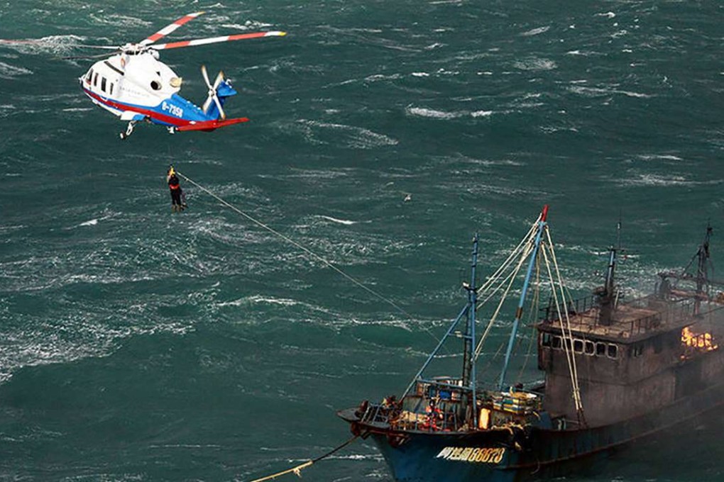 One of the 10 crew members is rescued from the stricken Chinese fishing boat. Photo: Thepaper.cn