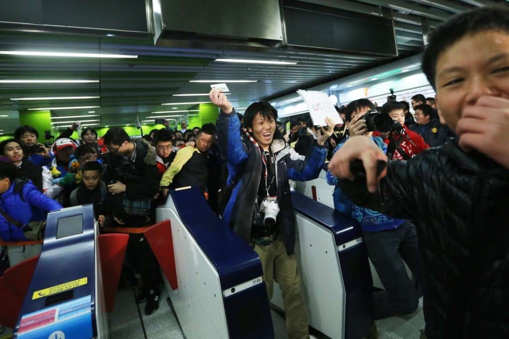Crowds flock to the turnstiles at South Horizons station as operations get under way. Photo: Sam Tsang