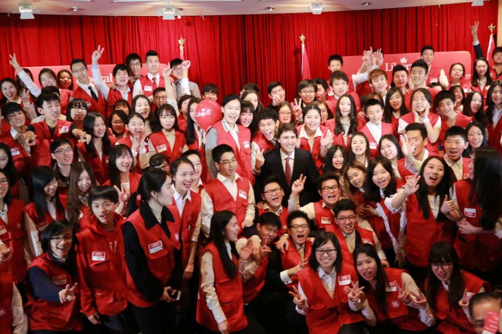 Justin Trudeau (centre) is surrounded by cheering members of the Tru-Youths United Association, a group that was based in Chinese corruption suspect Michael Ching Mo Yeung's office, at Vancouver's Floata restaurant on December 17, 2013. Two days earlier, an anonymous email warned the party that Ching was wanted by China for corruption. Photo: CNTVNA